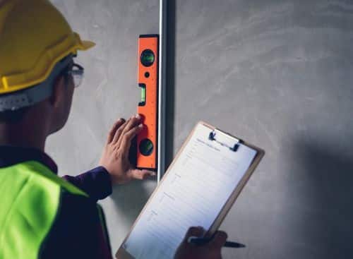 a man checking on the metal pipe with checklist as representation for the topic about Internet Marketing For Home Inspectors