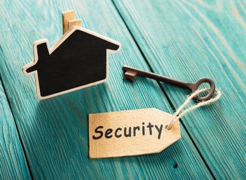 a house icon, a key and a security word place on a bluegreen surface as representation for the topic about home security company marketing