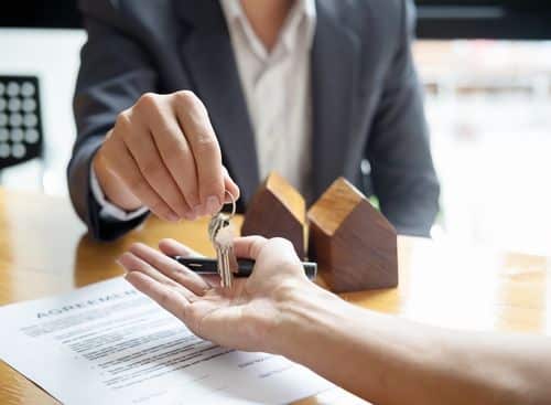 Real estate lawyer handling a key after contract signing