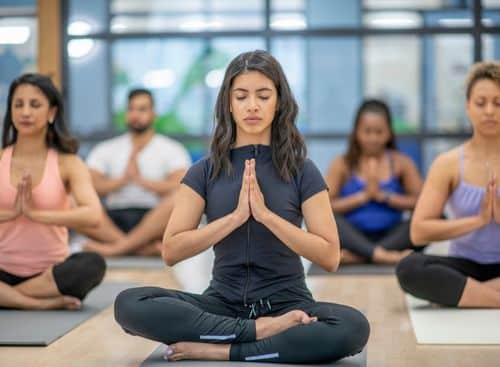 Yoga students meditating